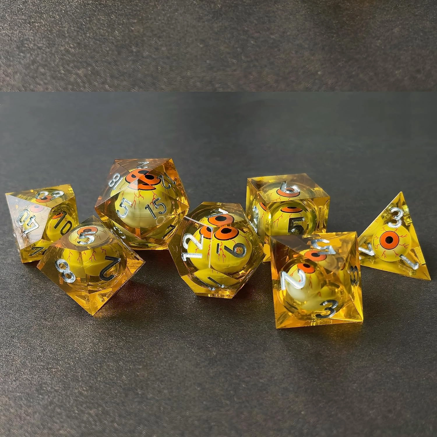 BESCON Sharp Edged Liquid Core Rolling Eyeball Polyhedral Dice Set - Razor Edge Polyhedral Dice with Rolling Eyeball Inside (7pcs Amber RPG Dice Set with Orange Eye)